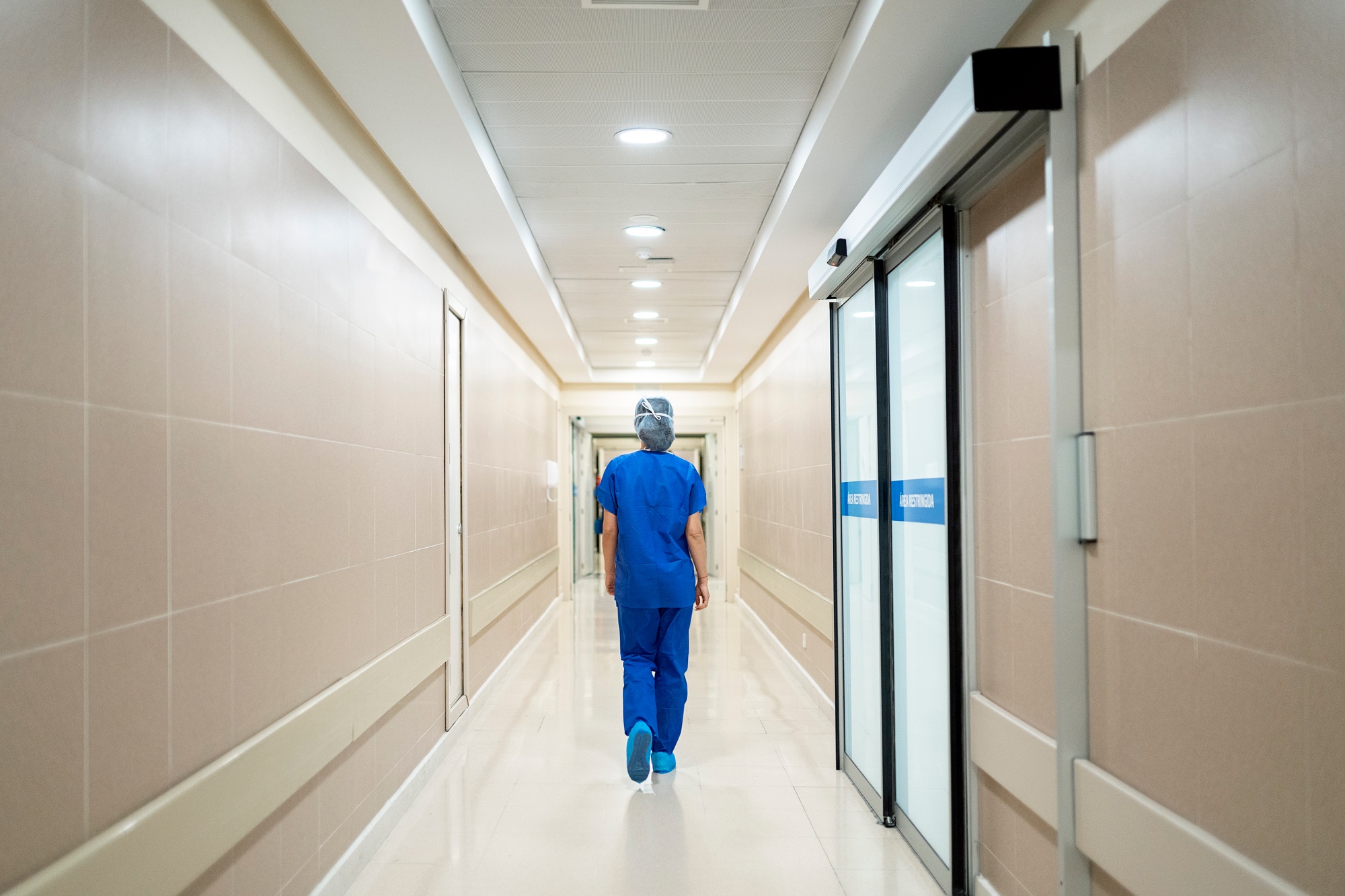 Female doctor walking along a corridor in the hospital